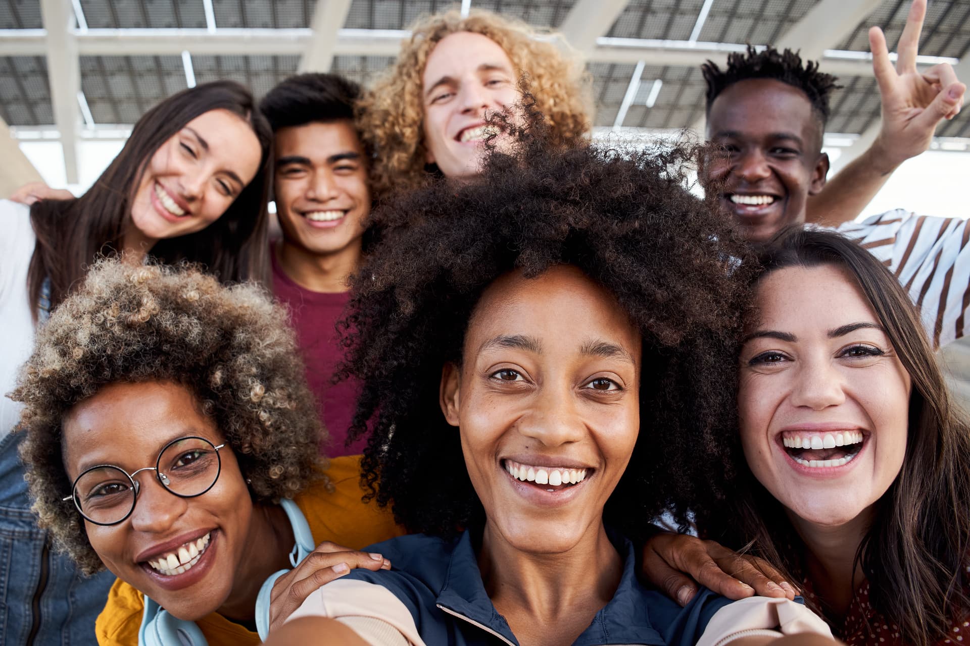 A diverse team of clients and clinicians smiling together